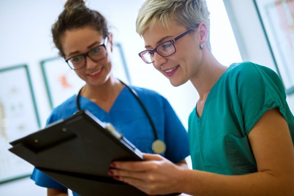 Close up view of two professional nurses with eyeglasses checkin